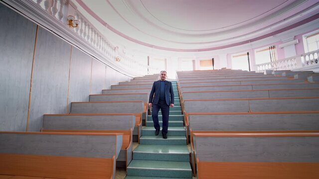 Lecturer in an empty lecture hall. An empty lecture hall in a University.