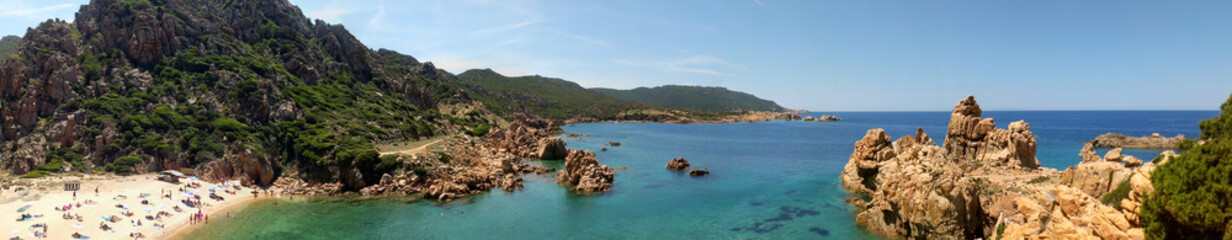 Fototapeta na wymiar Panoramic image of Li Cossi beach, hidden between some cliffs in Sardinia. Beach only accessible on foot, with turquoise water and unspoiled natural surroundings.