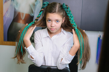 Teenager girl with colored pigtails
