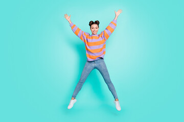 Full length body size view of attractive funny cheerful girl having fun jumping isolated over bright teal turquoise color background