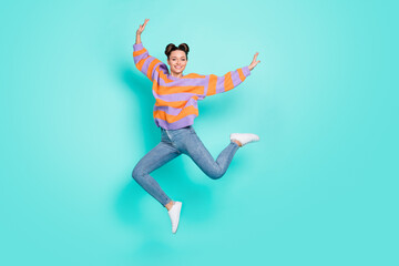 Full length body size view of attractive carefree slim cheerful girl having fun jumping dancing isolated over bright teal turquoise color background © deagreez