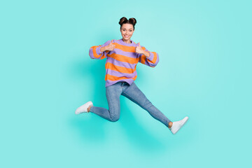 Fototapeta na wymiar Full length body size view of pretty trendy cheerful girl jumping showing thumbup cool isolated over bright teal turquoise color background