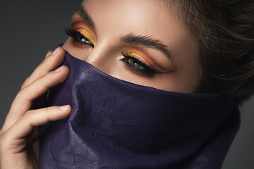Portrait of stylish woman wearing leather neck gaiter instead of prevention mask.