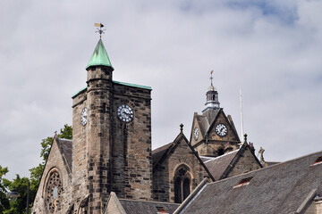 View of Two Towers with Clocks seen above Roofs of Public Buildings 