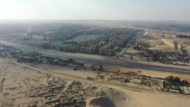 Aerial drone shot of Cairo Neighborhood in Desert near Pyramids, Egypt
