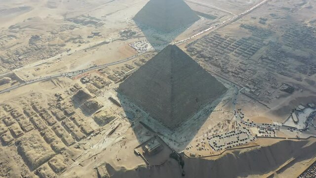 Aerial drone shot of all 3 pyramids from the top in Giza, Egypt