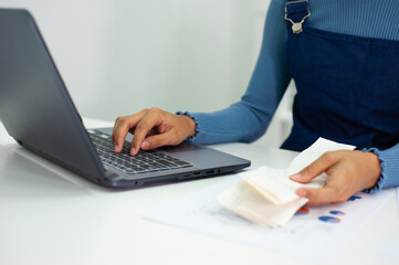A woman working on an accounting laptop.
