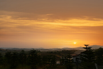 Orange glow of the morning sun on the mountain background