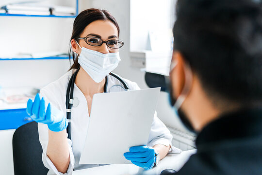 Woman Doctor During Patient Consultation, Wearing Protective Mask And Gloves, Safe Medicine, Asia