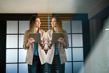 Portrait of professional business woman with digital tablet in corporate office