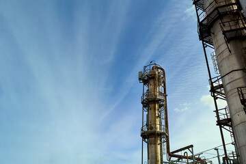 Oil refinery chemical plant bottom view with copyspace over blue evening sky with clouds...