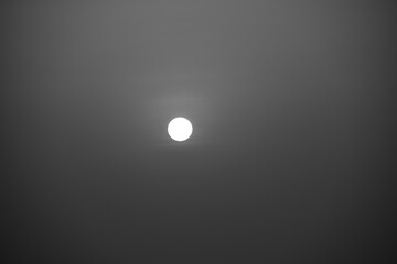 a black and white picture of the stunning sun