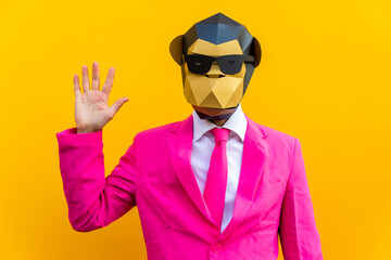 Man with funny low poly mask on colored background