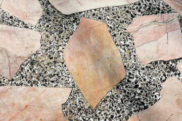 Old marble table top with small pebbles.