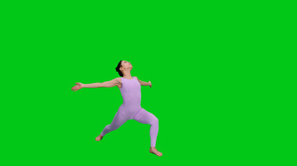 Young woman in bodysuit practicing yoga warrior pose on green screen background