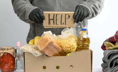 collects food, fruits and things in a cardboard box to help the needy and the poor