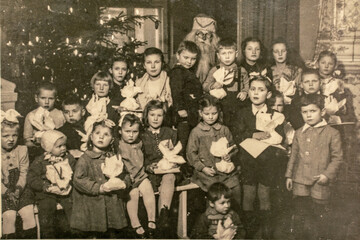 Germany - CIRCA 1940s: Group photo of small kids girls boys and Santa Claus on Christmas New Year...