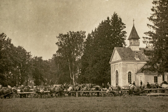 Latvia - CIRCA 1910-1920: Many horse drawn carriages buggies parked at a rural church on sunday. Vintage Carte de Viste Edwardian era photo