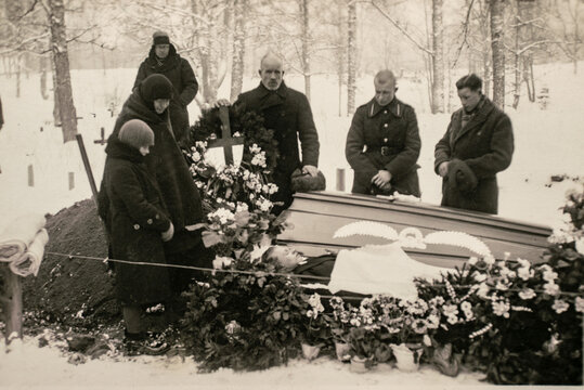 Latvia - CIRCA 1930s: People at funeral ceremony. Group photo in cemetery. Vintage archive Art deco era photo