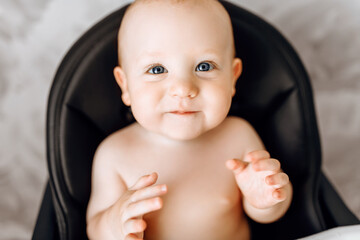 child sitting in a baby chair, baby food concept