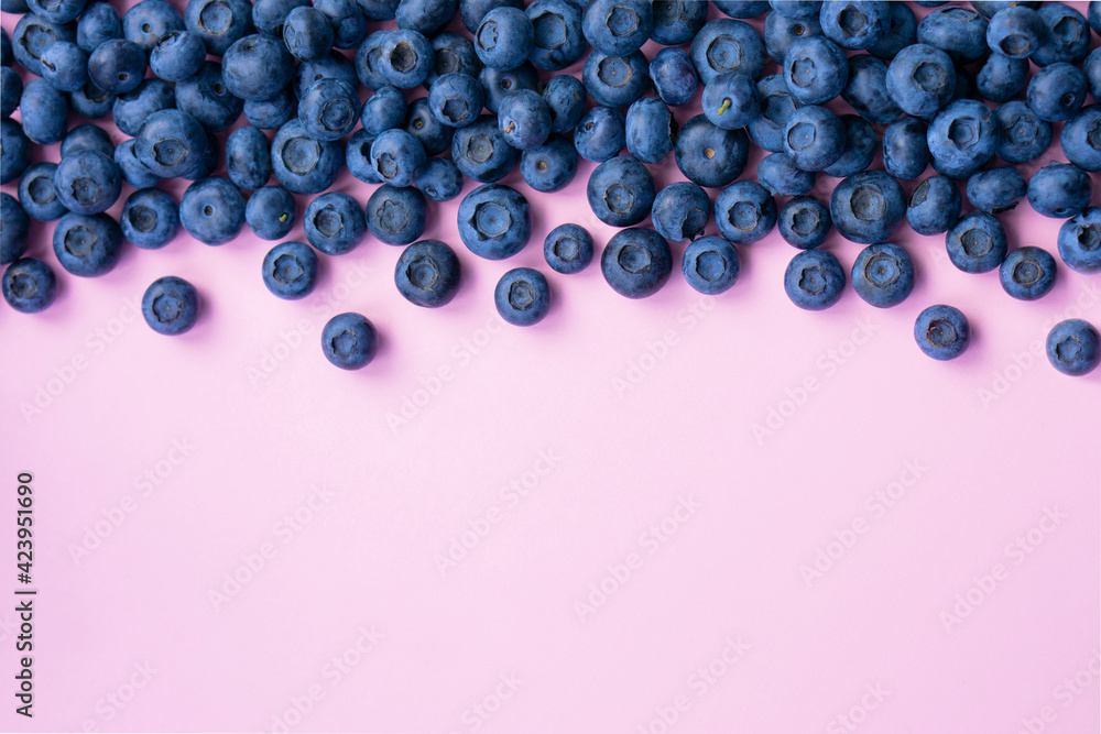 Wall mural delicious fresh blueberry on pink background with copy space . top view .advertising concept.