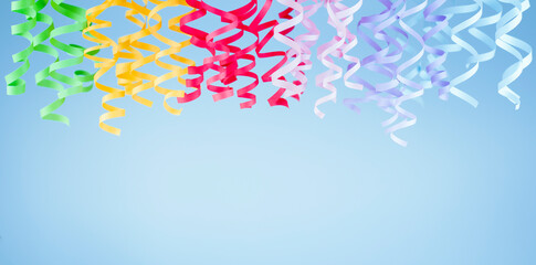 multicolored streamer hanging on a blue background. birthday decoration