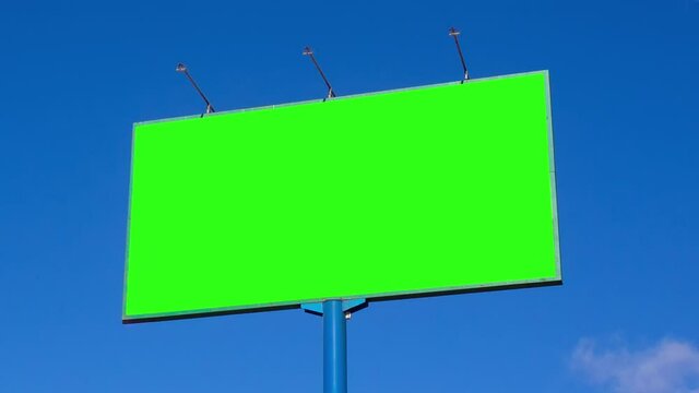 Green screen. Billboard over blue sky with clouds.