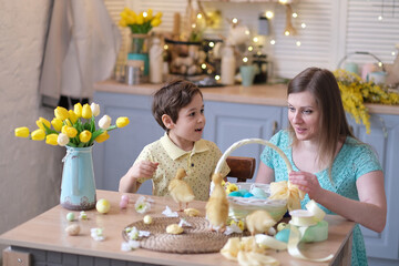 Mother and son having fun together and celebrating feast. family getting ready for easter. Little and mom decorating home. soft focus