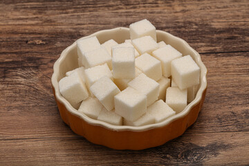 Refined white sugar cubs in the bowl