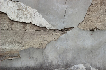 Naklejka na ściany i meble Old cracked plaster on a concrete wall, background