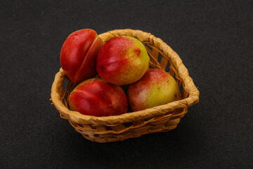 Sweet small nectarines in the basket