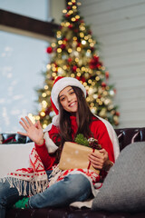 Girl holding a Christmas present on New Years Eve.