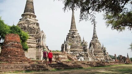 Couple of tourist in Ancient Ruins of Thailand - Powered by Adobe