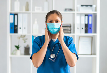 Fototapeta na wymiar Professional medical doctor working in hospital office, Portrait of young and attractive female physician in protective mask.
