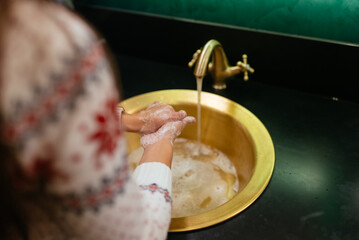 Close up photo of woman washes her hands with soap and water.