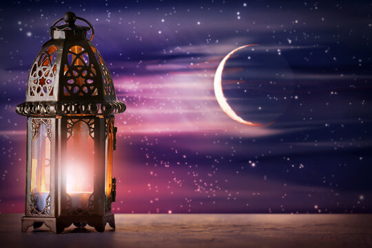 Muslim lamp on table against night sky