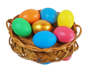 Colorful Easter eggs in the basket reflecting on the white surface, isolated