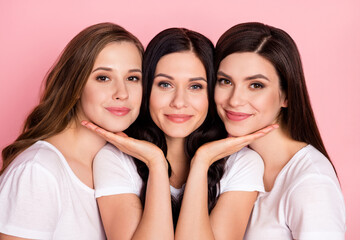 Photo of three young attractive girls happy positive smile family sisters isolated over pink color background
