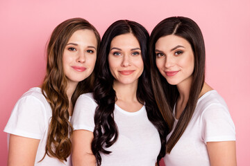 Photo of three young attractive woman happy positive smile friends isolated over pink color background