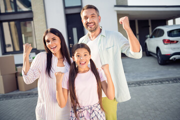 Photo of hooray family hands fists remove with boxes wear casual cloth near home outdoors