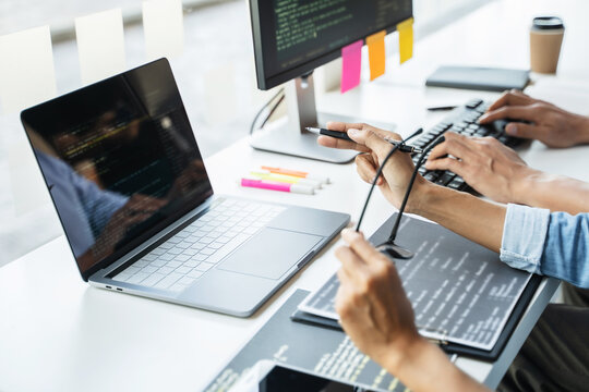 Programming developing software application. programmer writing program code with two monitors and working hacker on a new software
