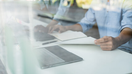 programmer writing program code with two monitors and working on a new software or hacker programming developing software applications