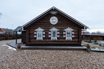 wooden house with decorative carved shutters on the windows. the facade of a country holiday home for tourists in a traditional European style