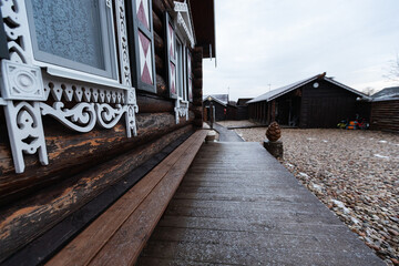 wooden house with decorative carved shutters on the windows. the facade of a country holiday home for tourists in a traditional European style