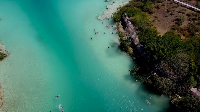 Aerial View People In Crystal Clear Turquoise Water Laguna Bonanza Lagoon Bacalar Mexico Drone 4K