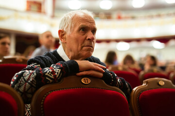 Elderly man enjoying performance at opera and ballet theater