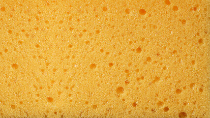 Yellow soft porous texture as background. Yellow abstract background.