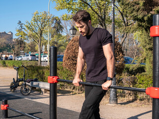 MAN DOING TRAINING STREET WORKOUT IN PARK