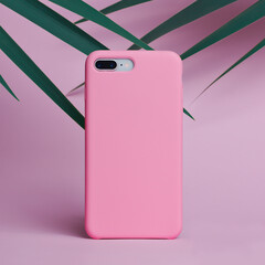 white smart phone case mockup on a pink background of palm leaves