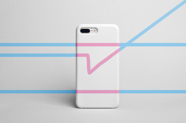 Smart phone in a white plastic case back view on gray background with a blue and pink thin lines in...